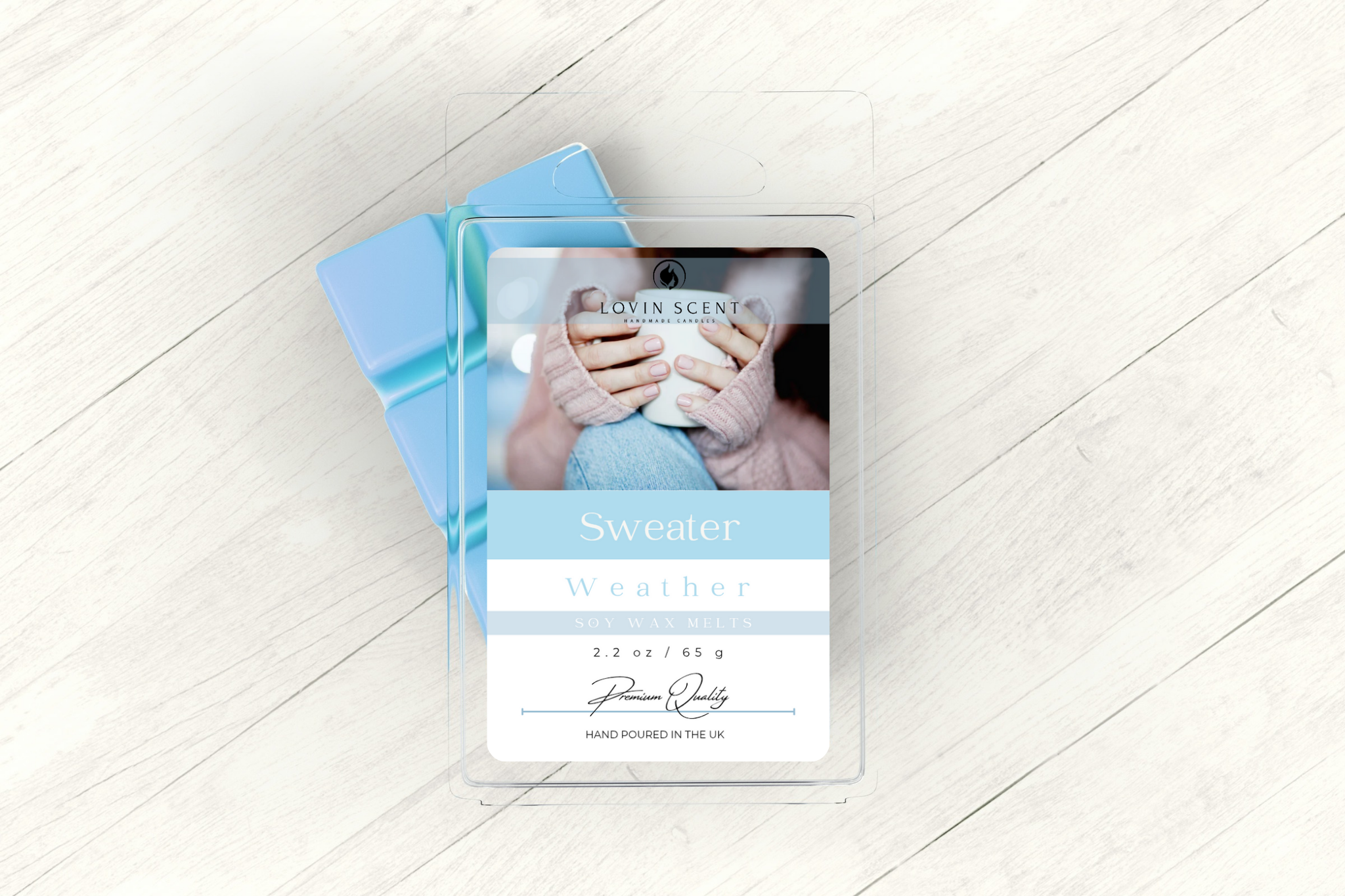 Product packaging with a blue ribbon on a light wooden floor