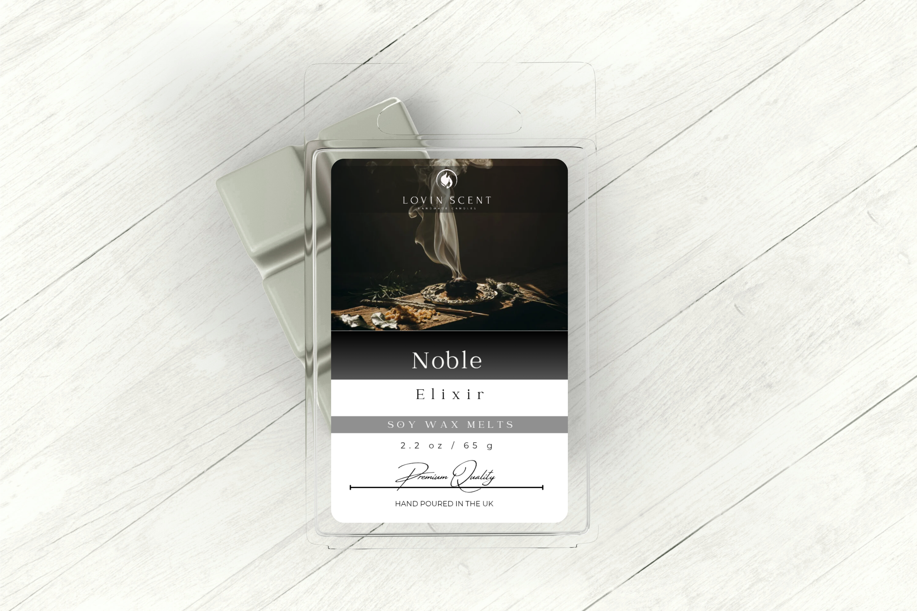 Scented candle packaging with 'Noble' label on a white wooden surface