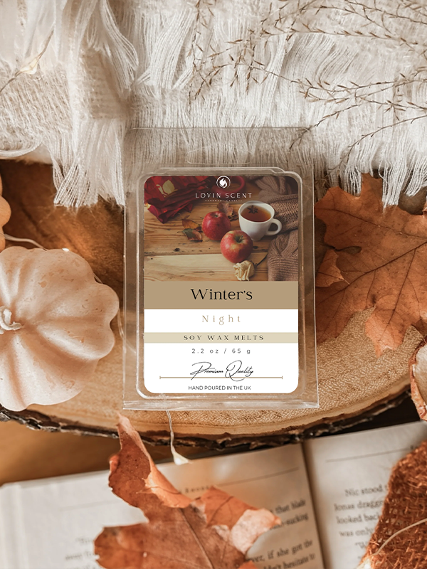 Wax melt package labeled 'Winter's Night' on a decorative surface with pumpkins and leaves.