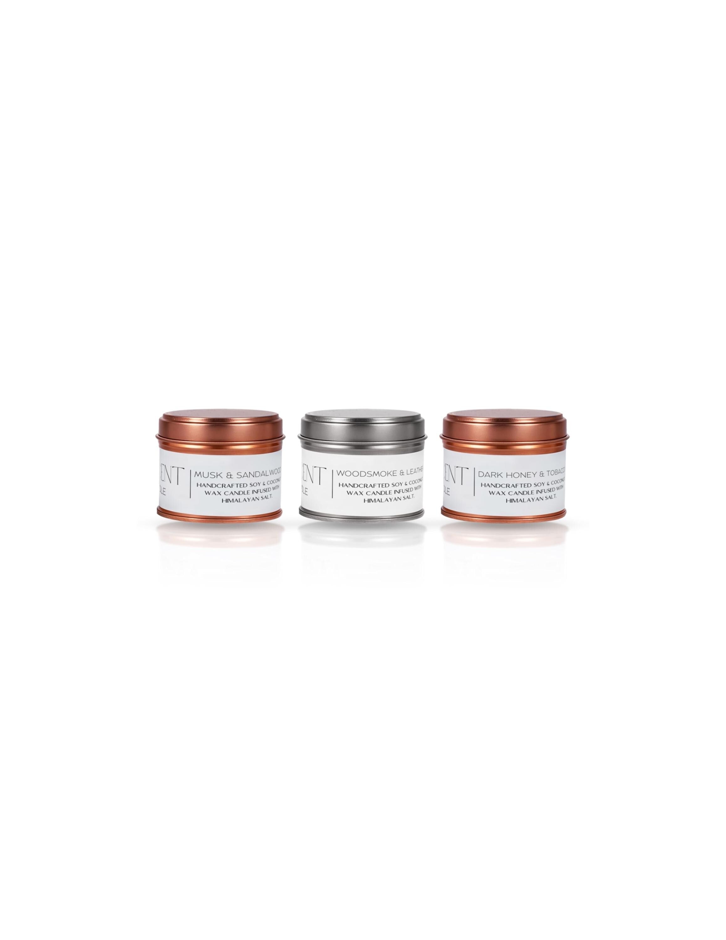 Three small jars with metallic lids on a white background