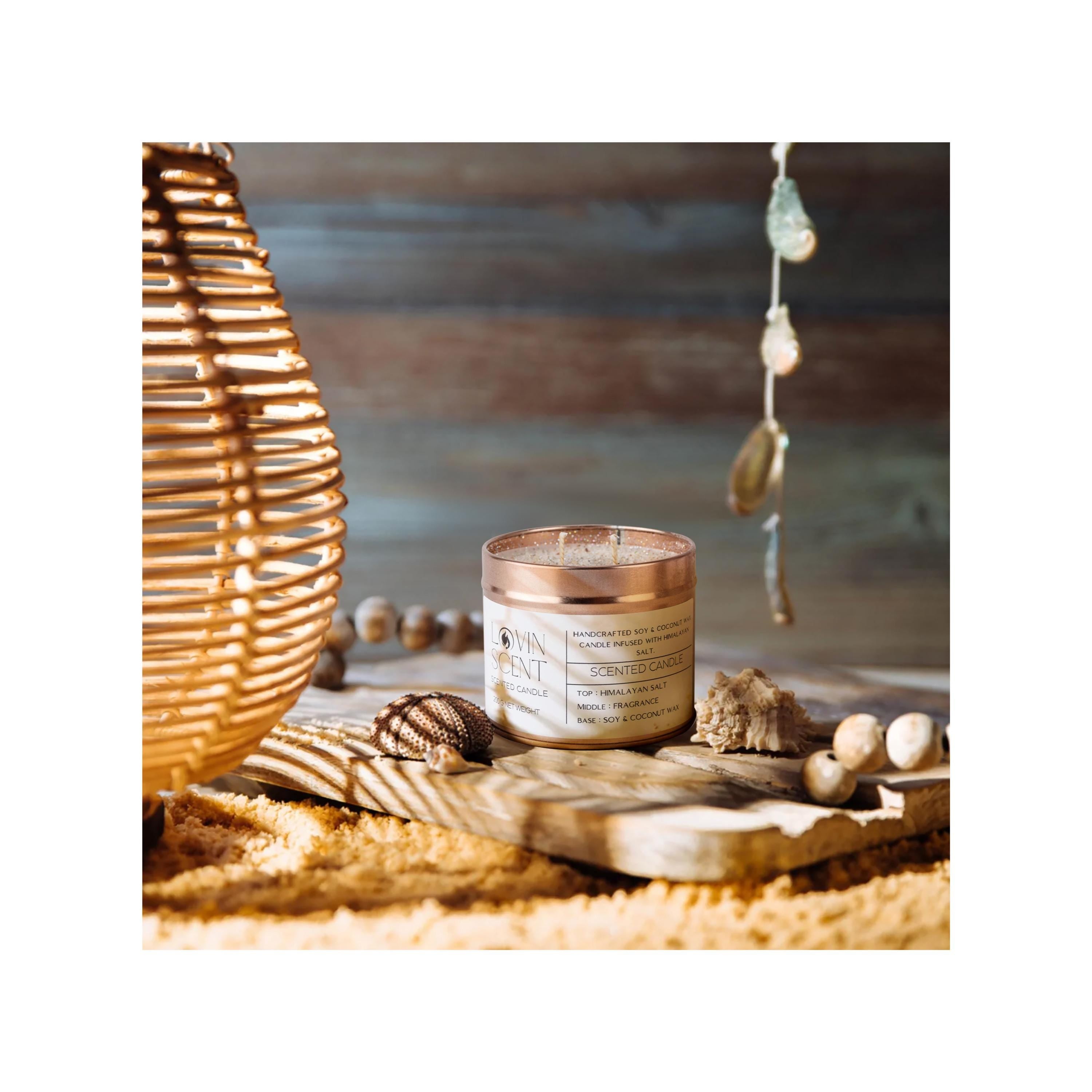 Candle in a decorative container with natural elements on a wooden surface