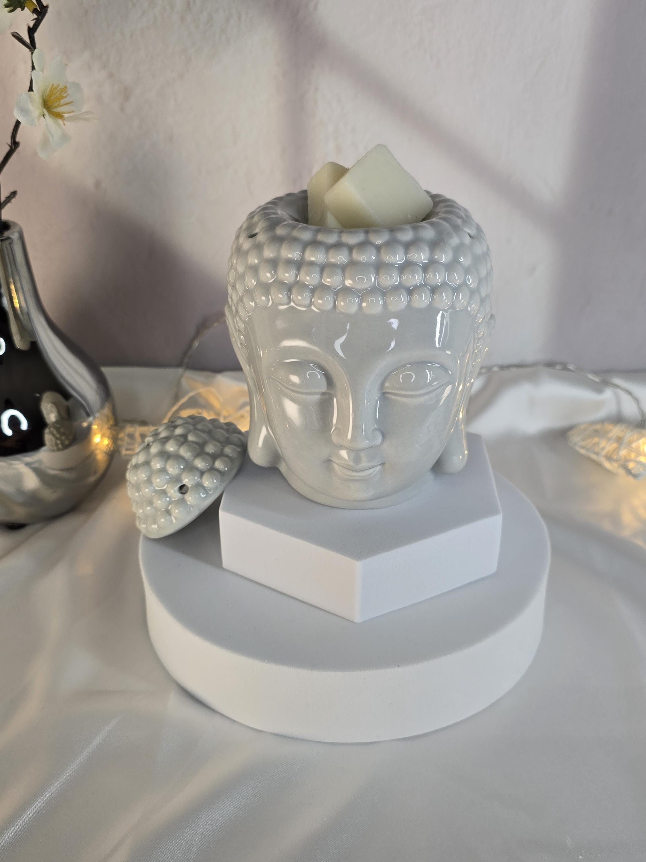 Decorative item with Buddha head design on a white surface