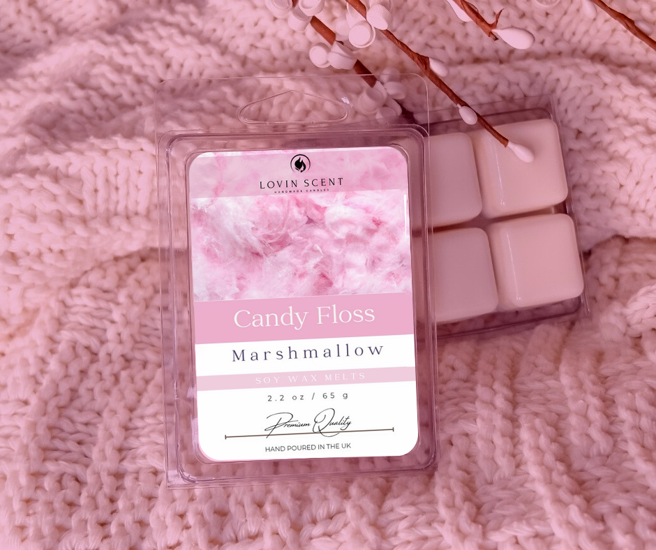Packaged candy floss marshmallow scented wax melts on a pink textured surface