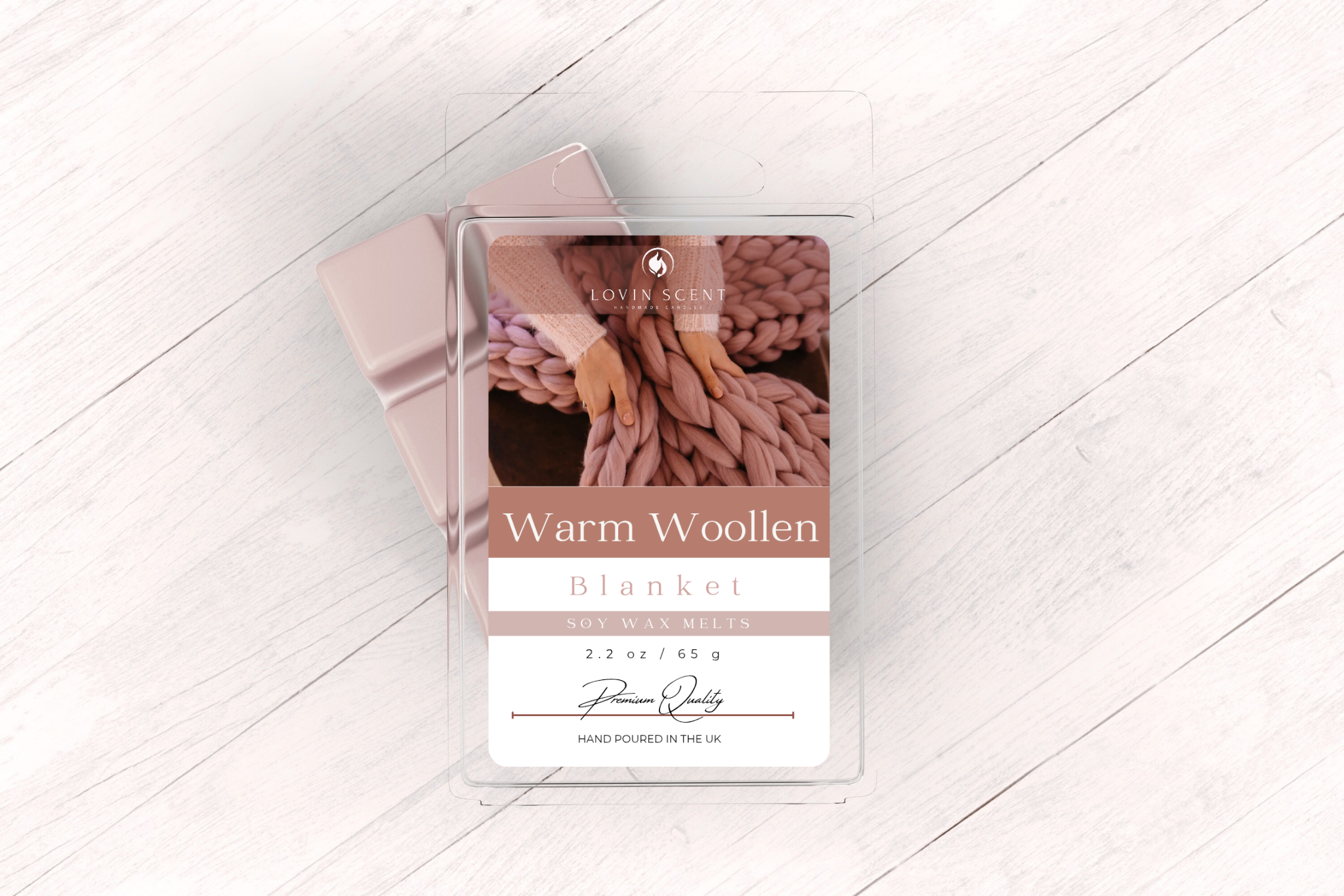 Packaged warm woollen blanket with brand label on a light wooden floor.