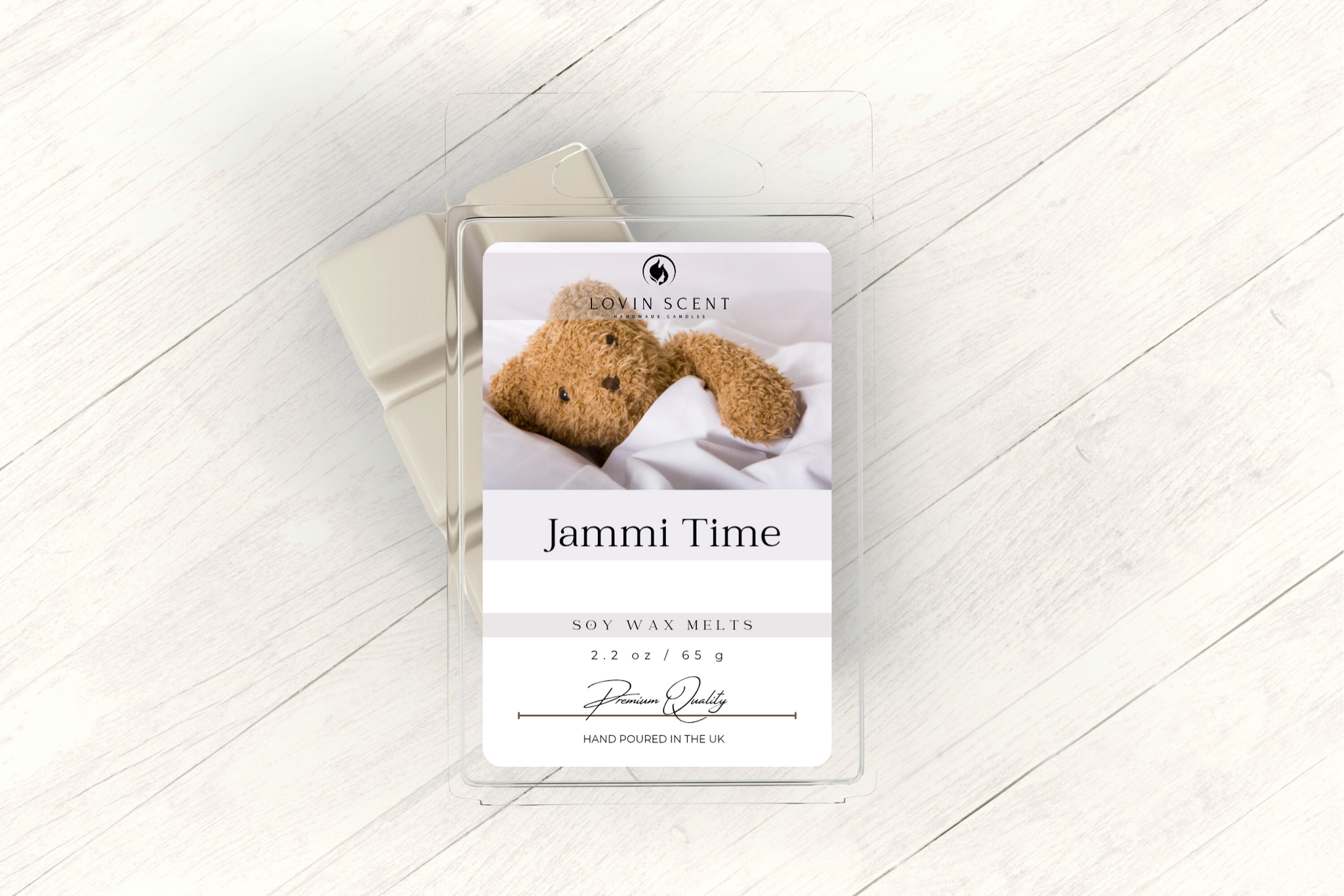 Wax melt packaging with teddy bear illustration on a light wooden surface
