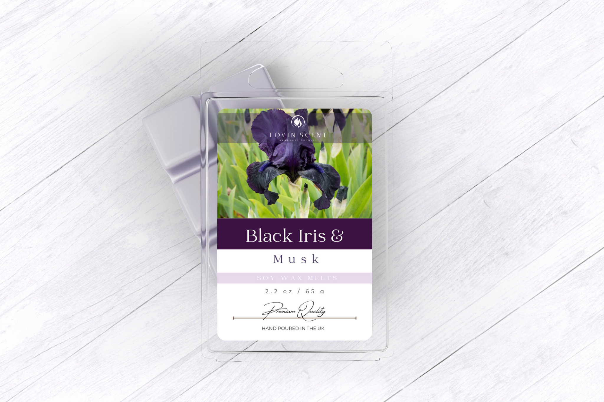 Candle packaging with 'Black Iris & Musk' label on a white wooden surface
