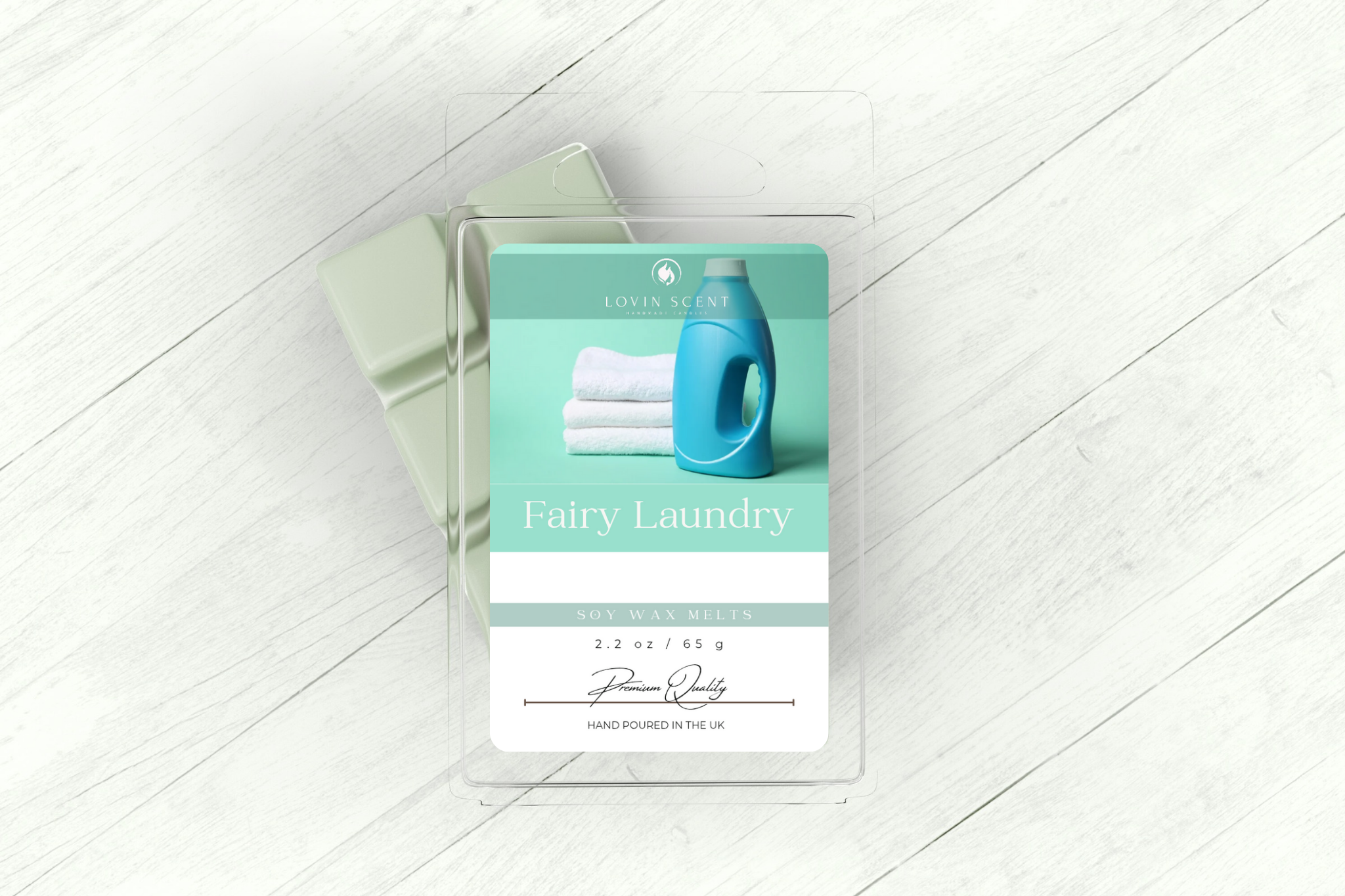 Fairy Laundry detergent pod packaging on a white wooden floor