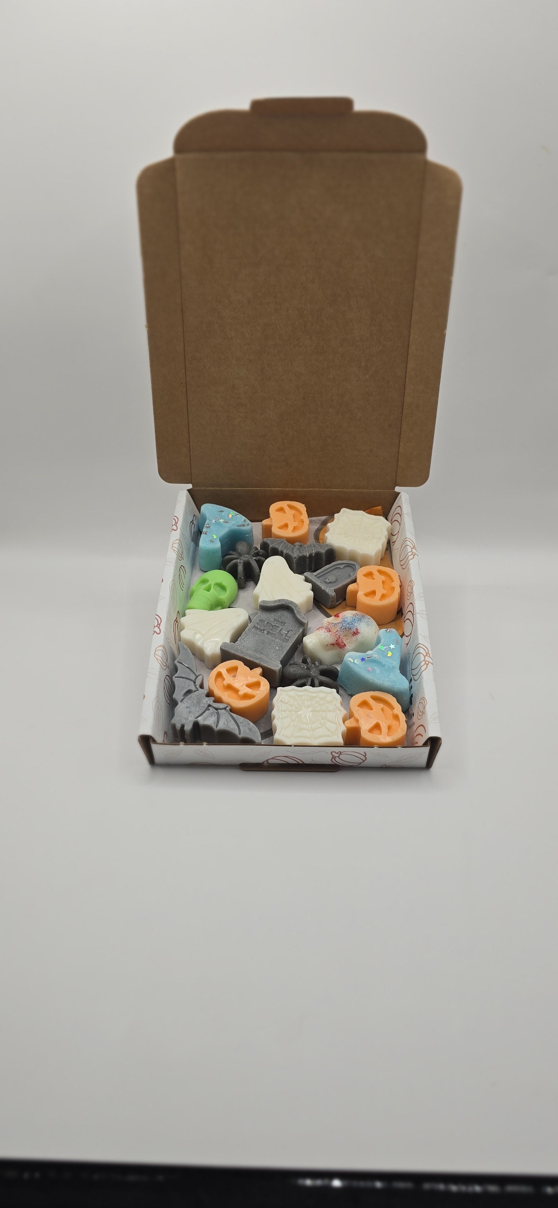 Box of assorted small toys on a white background