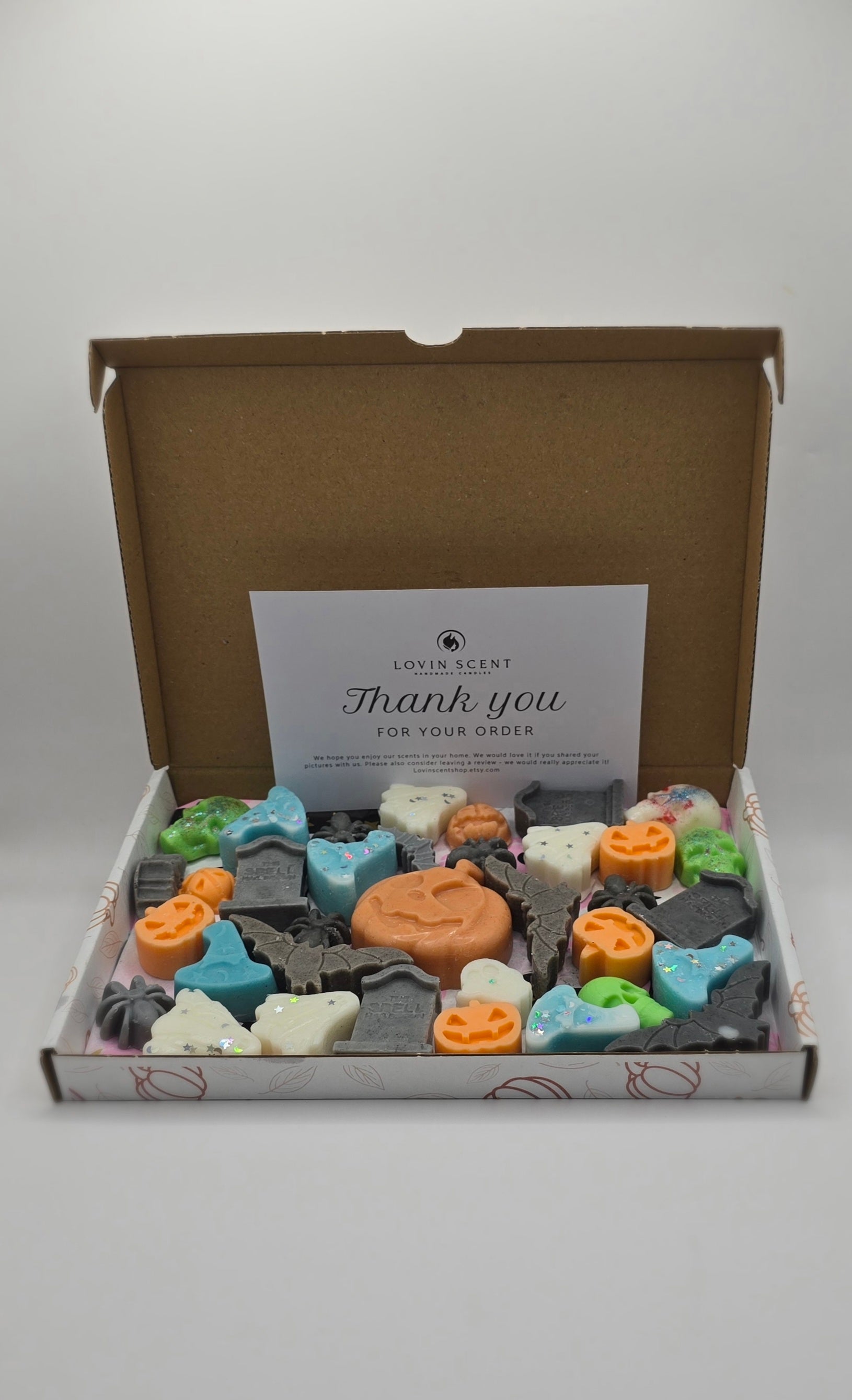 Box of assorted small soap bars with a 'thank you' card on a white background