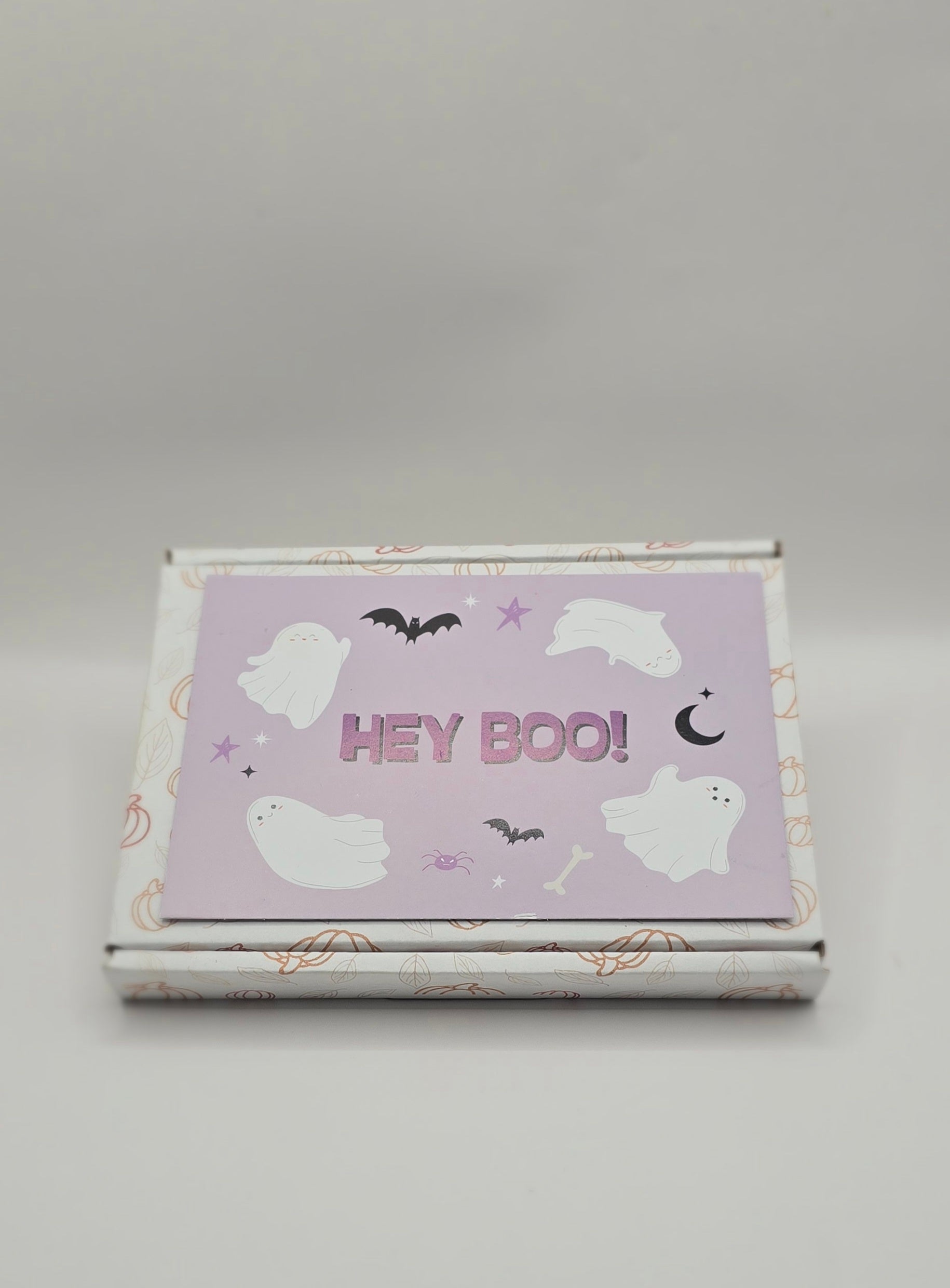 Halloween-themed product packaging with 'HEY BOO!' text on a light gray background