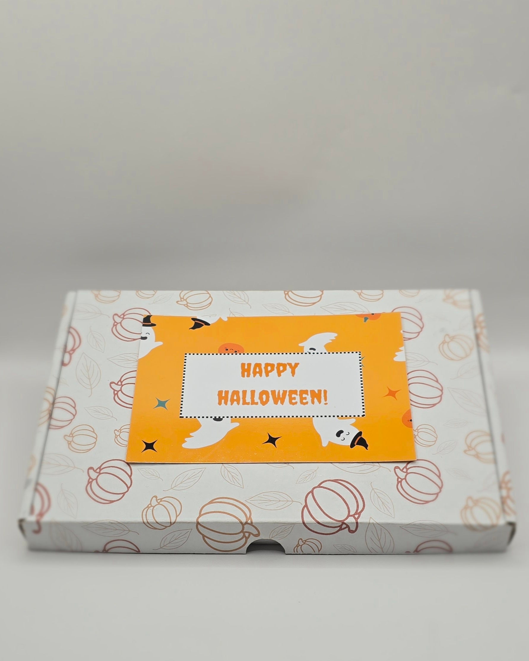 Box with Halloween-themed design and 'Happy Halloween!' text on a gray background