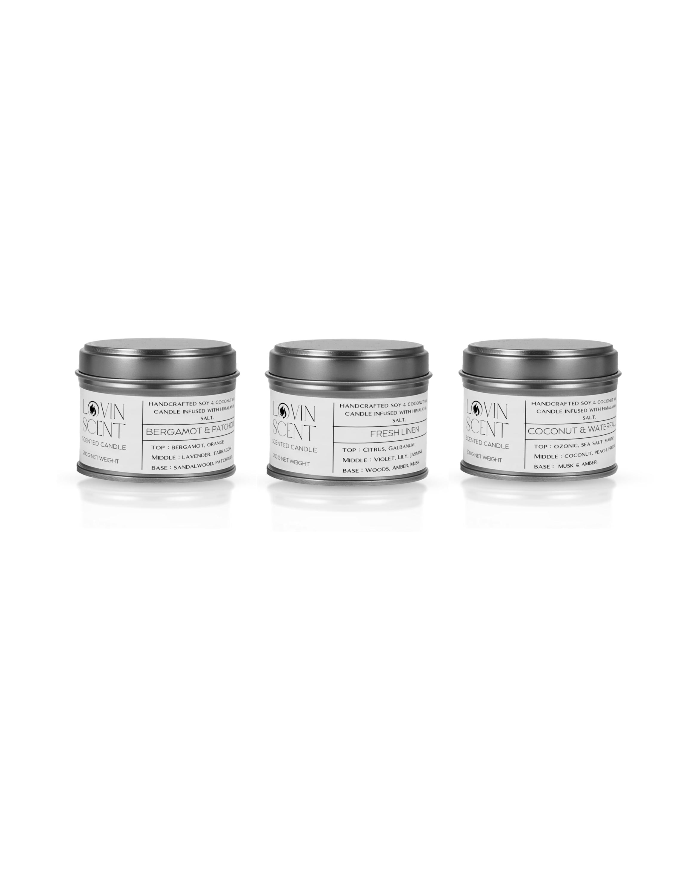 Three tins of different scents on a white background