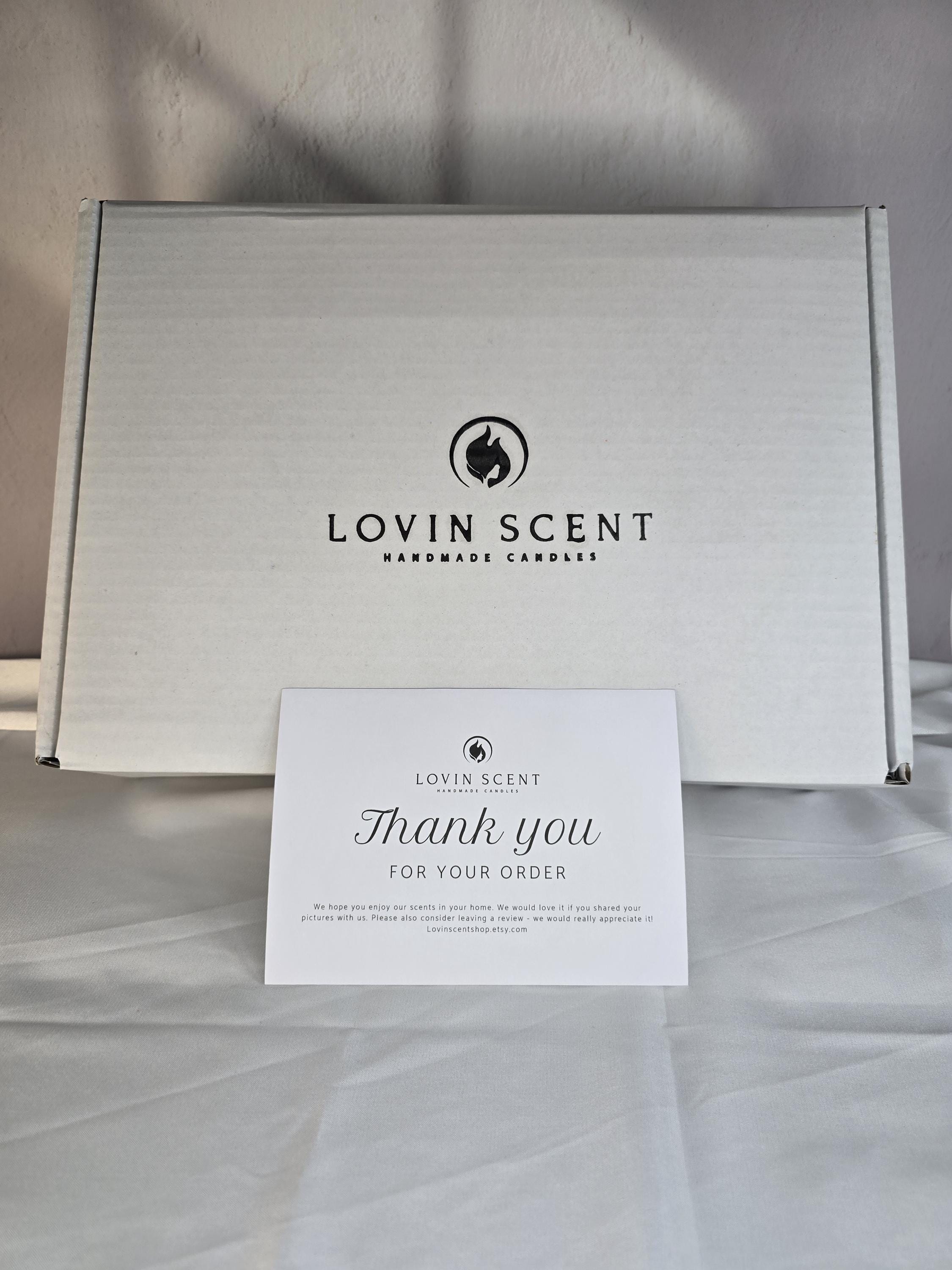 White box with 'Lovin Scent' logo and a 'Thank you for your order' card on a light background